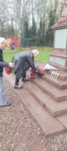The Chair of the Parish Council, Sue Emery, lays a wreath in the centre of the armed forces memorial.